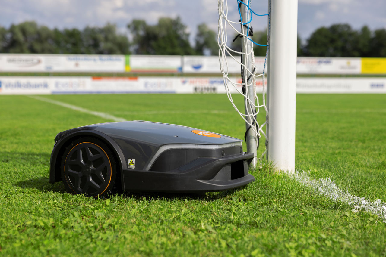 Primo piano: il robot rasaerba iMOW 7 PRO falcia il campo sportivo